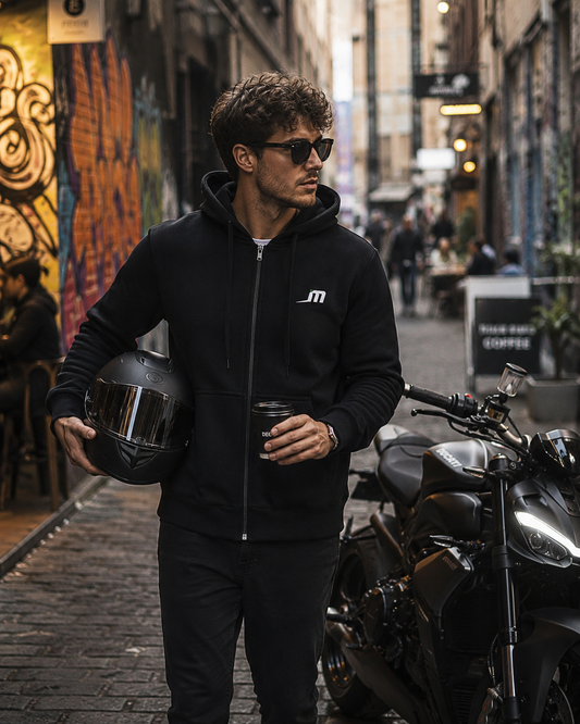 Rider wearing the Guardian kevlar motorcycle hoodie with helmet and coffee in hand