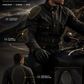 A man wearing a black motorcycle jacket with integrated protective armor pads, shown riding outdoors with callout lines highlighting shoulder, elbow, and back protection areas. The image includes marketing text and a small inset close-up of the back protector design.
